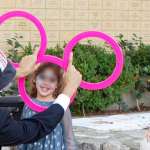 Juggler entertains children at party forming Mickey Mouse with three juggling rings